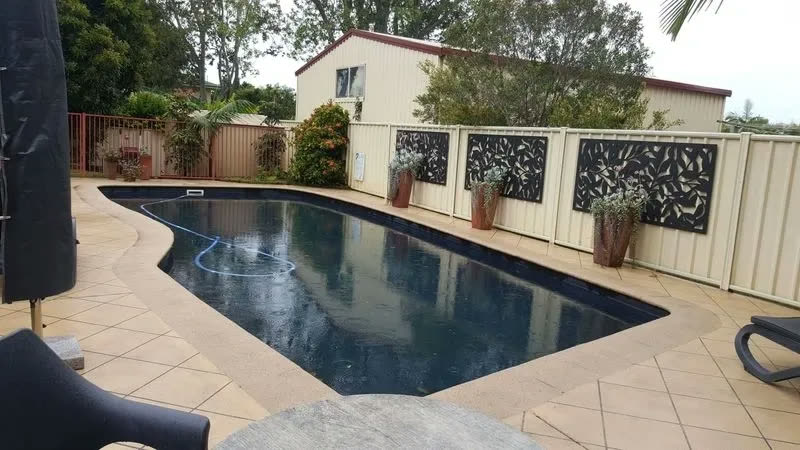 The same pool surround pressure washed back to clean tile
