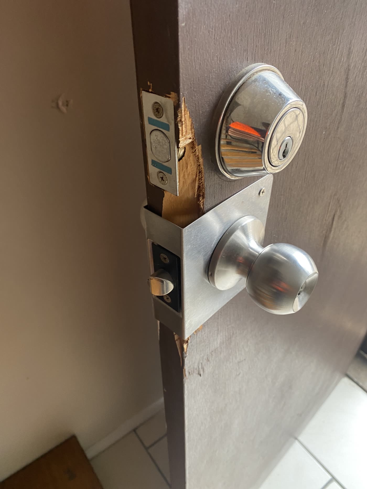 A door edge splintered around the lock