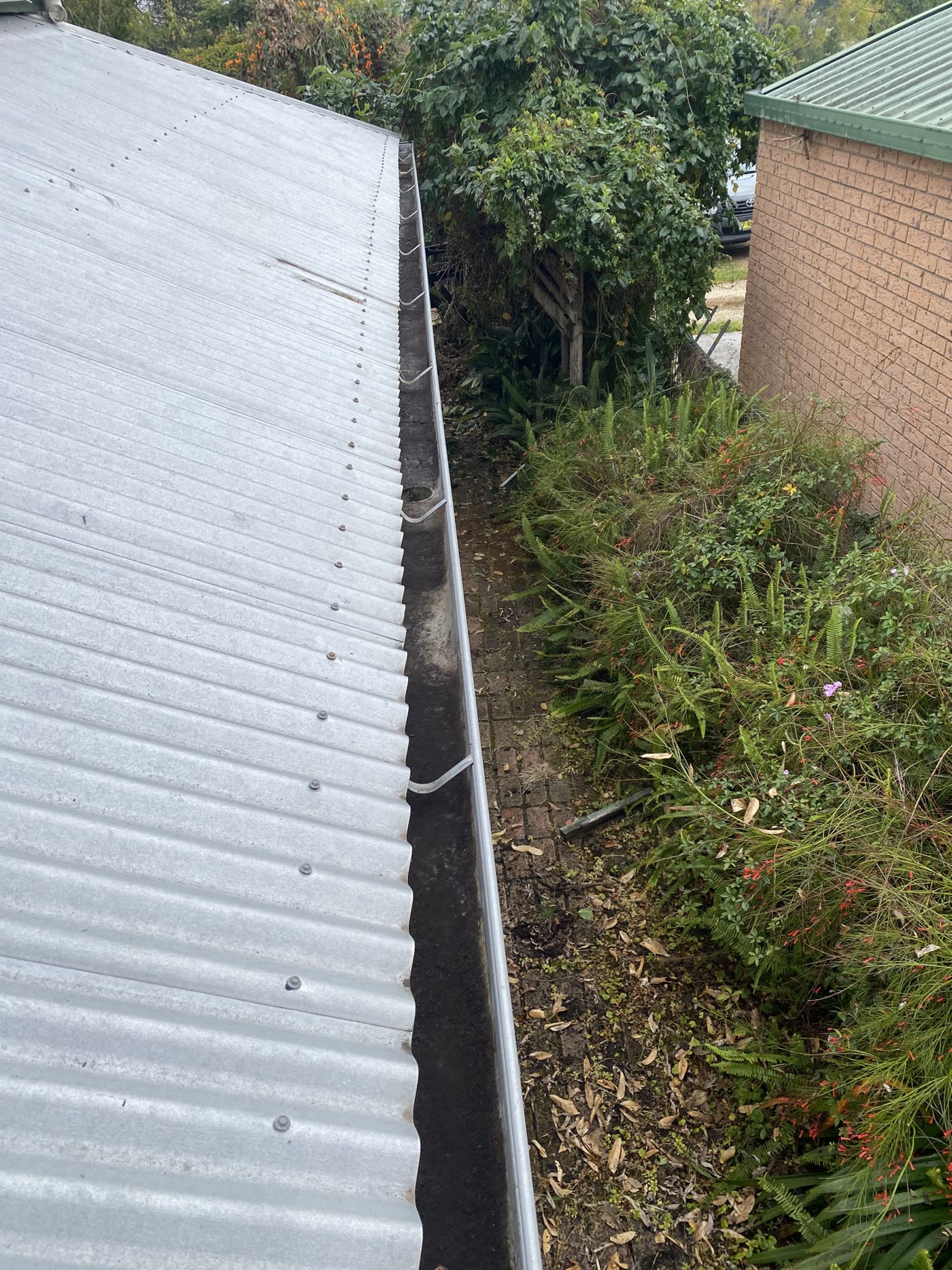The same gutter run cleared and clean