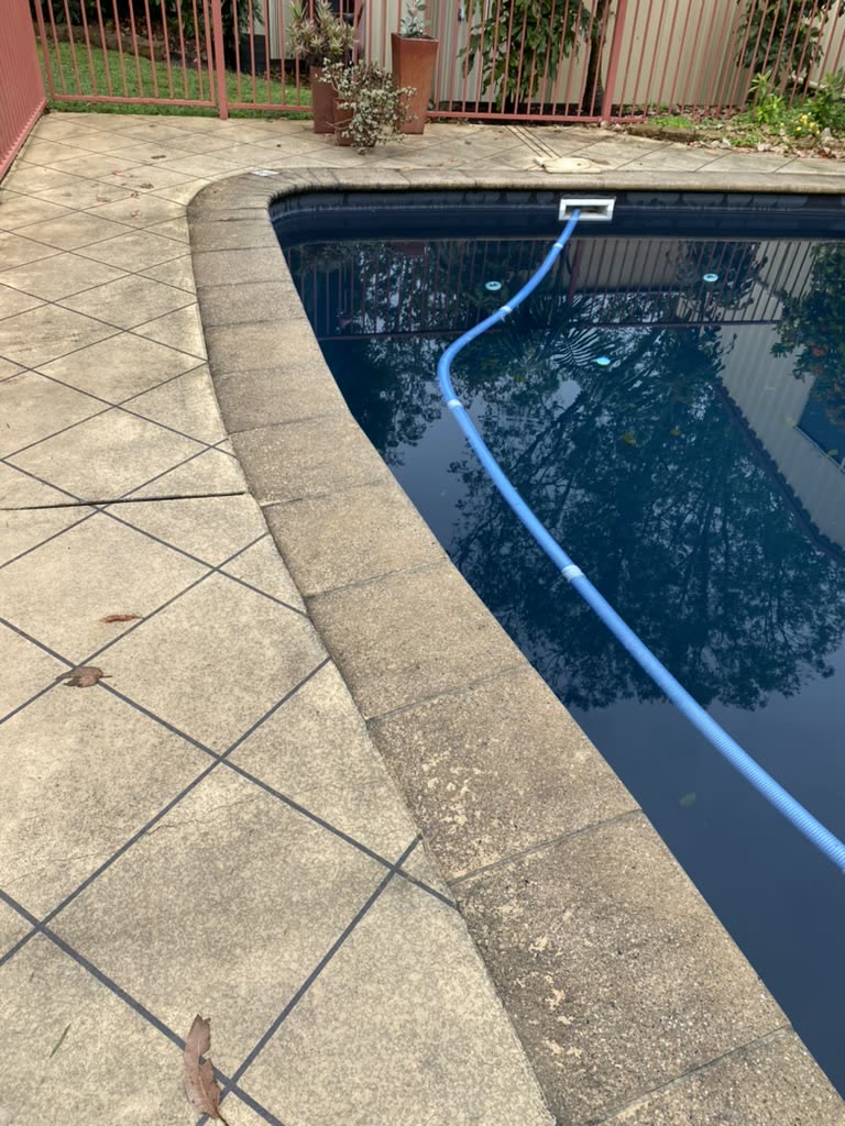 A stained tiled pool surround
