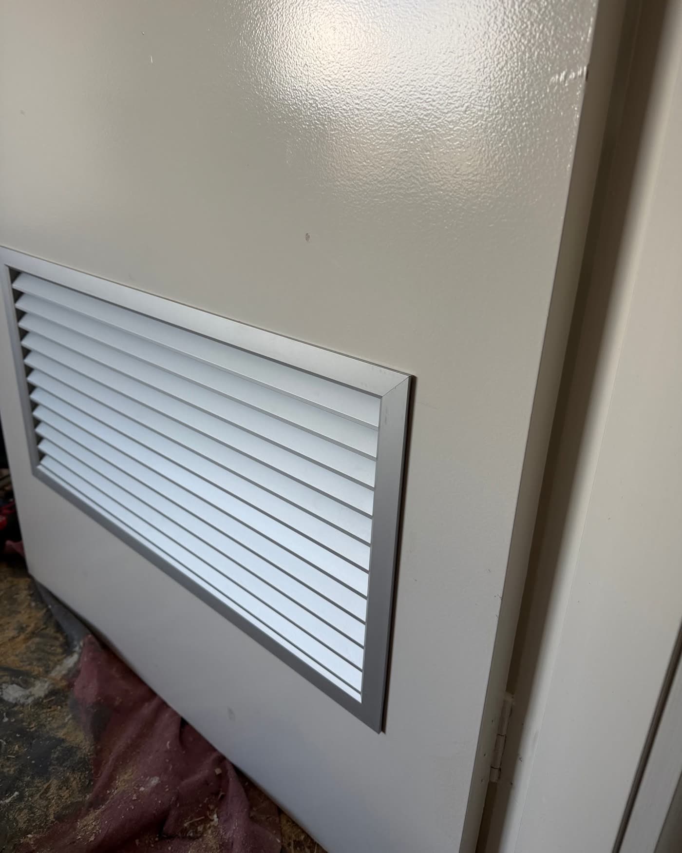 A vent grille fitted into the same door
