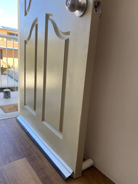 A weather seal fitted along the base of the same door